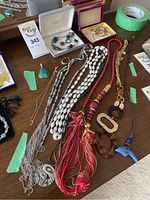 Several necklaces, bracelets, pendants and a ring laid out on a table