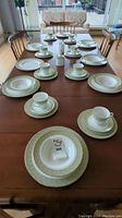 Full table view of Royal Doulton Sonnet fine china dinnerware arranged for 8 minus one soup bowl