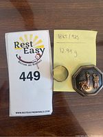 Photo of the ring and octagonal brooch with weight note