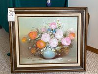 Full view of the framed oil painting showing floral bouquet in vase.