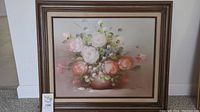 Full view of the framed floral bouquet oil painting showing the entire composition and frame.