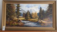 Full view of the framed oil painting showing the landscape scene with river, trees, and mountains.