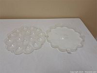 Plastic devilled egg serving tray and clip-on lid side by side showing the inside and outside of the set.