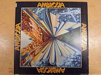 Front cover of Ambrosia vinyl LP album with abstract artistic design and band name in yellow lettering
