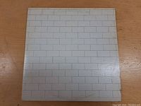 Front cover of the album with brick wall design.