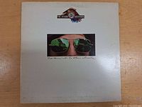 Front cover of The Doobie Brothers 'Takin' It To The Streets' vinyl LP showing album artwork of sunglasses reflecting a cityscape.