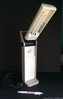 OttLite craft light in an open position showing the fluorescent bulb and the brand name.