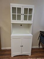 Front view of assembled white storage cabinet with upper glass door hutch and lower cabinet