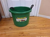 Green plastic tub showing overall size and shape with black handles and label.