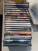 Stack of assorted DVD cases with titles visible on spines