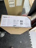 Sealed original Dyson V11 Dock wall mount box showing product details and measurements on packaging.