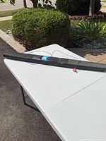 Full-length view of black soundbar on folding table outdoors