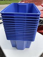 Stack of 10 blue plastic storage buckets showing size, shape, and color.