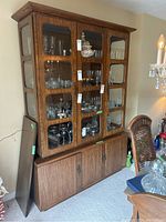 Full view of buffet and hutch set with glass doors displaying glassware inside