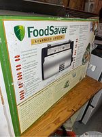 Box with FoodSaver branding showing product features and model V2490