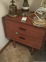 Nightstand showing overall front and side view with lamps and cords on top