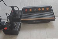 Photo of Atari Flashback 3 console with two joystick controllers showing the front and top design.
