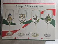 Box image showing the set titled Songs Of The Season by Block Basics with four glasses depicted featuring different holiday designs (snowman, wreath, reindeer, tree).