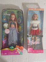 Front view of Ariel and Holiday Wishes Barbie dolls in original packaging, showing Ariel's damaged box