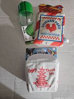 Green and clear plastic chew toy dispenser, plush toys shaped like food bags with tags