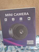 Front side of the box showing mini camera image and key features: night vision, WiFi, app control, HD image.