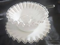Diagonal angle showing the full size and shape of the Fenton Silver Crest mayo bowl, featuring the ruffled, silver-edged rim and glass spoon inside the bowl.