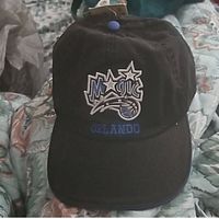 Front view of the black Orlando Magic cap showing logo and text details on front panel.