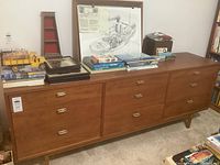 Front view of the dresser with items placed on top, showing overall appearance