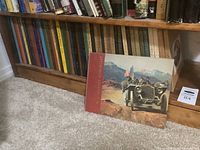 Photo showing a bookshelf with multiple Automobile Quarterly hardcover books with spines facing outward showing volume and issue numbers.