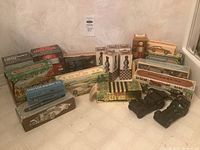 Overview of multiple Avon collectible cologne bottles and boxes arranged on floor