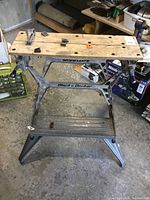 Full view of Black & Decker Workmate workbench showing wooden slatted top and sturdy metal frame with lower shelf.