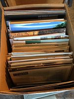 Bankers box filled with loose brochures viewed from above