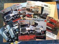 Selection of GMC catalogue front covers laid out