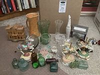 Wide view showing all items in collection including glass vases, miniature bottles, and musical carousel horse figurines