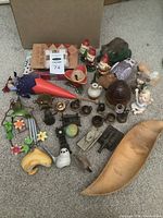 Overview of assorted vintage collectibles including toy clown, ceramic gnomes, miniatures, and a wooden bowl