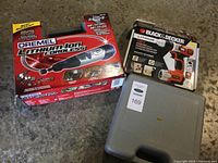 Two boxed tools - Dremel Lithium-Ion Cordless Rotary Tool kit and Black & Decker 12V Lithium Drill/Driver with grey tool case.