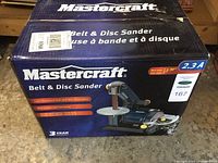 Photo of unopened Mastercraft Belt & Disc Sander box showing product name and image on front.