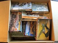 Multiple boxed model kits in a cardboard box.