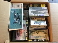 Top view of box containing Solido Curtiss SB2C-4 Seadiver, Heller Les Mureaux 117, Heller Peugeot 203, CJ-5 Golden Eagle Jeep and Renault 4CV kits