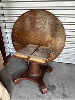 Top round surface visible, leaning against wall with underside showing.