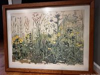 Full front view of the framed botanical print 'Meadows' showing colorful meadow plants and brown oak frame.