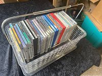 Side view of clear plastic carrying basket filled with classic music CDs