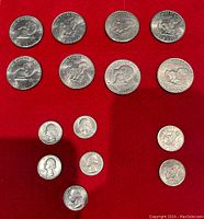 First image showing some of the quarter and dollar coins arranged on red background.