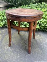 Front angled view showing curvature of legs, seat and wood band with missing screws.