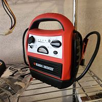 Black & Decker portable battery charger/jumper with cables and controls visible