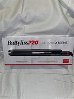 Photo of BaBylissPRO Ceramix Xtreme flat iron in packaging showing front and branding.