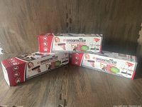 Three boxed Broomster Rubberized Brooms stacked with label and product details visible, showing new condition.