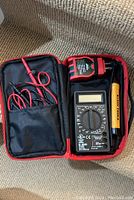 Overview of electrician tools kit including digital multimeter, voltage detector, and socket tester all inside carrying case.