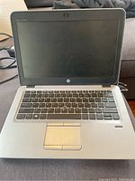 Front view of HP EliteBook 725 G3 laptop showing keyboard, touchpad and screen.