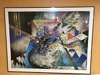 Front view of large framed abstract art print showing multiple colors and geometric shapes. Signature visible.